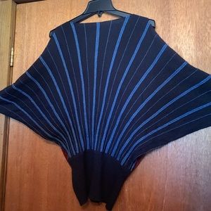 Shinny blue, black, and white poncho-like sweater